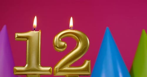 Golden Number Twelve Candles Burning at Birthday Party