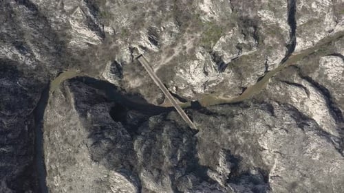 Descending on river canyon and railroad bridge 4K aerial footage