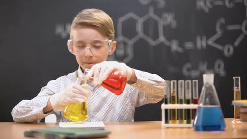 Boy Experiments in Chemistry Lab Mixing Liquids