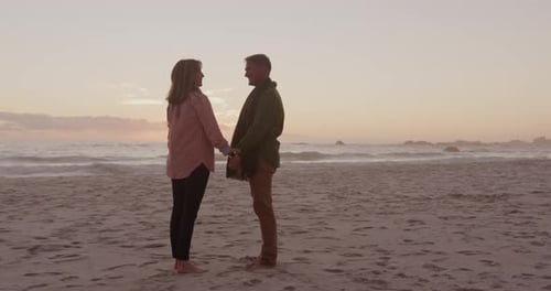 Active senior couple standing on beach
