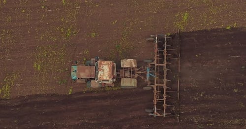 Tractor is Plowing Soil on Agricultural Field in Seeding Season View From Drone Prores