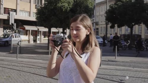 Street Photographer, Woman Is Taking a Photo on Vintage Camera