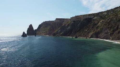 Aerial View From Above on Calm Azure Sea and Volcanic Rocky Shores