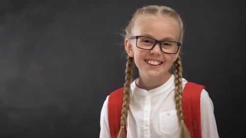 Smiling Girl with Braids Wearing Backpack and Glasses