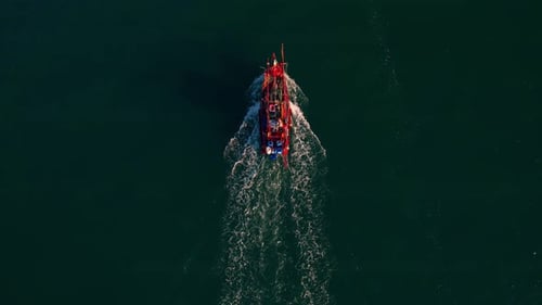 Fishing boat sailing in the sea near river mouth