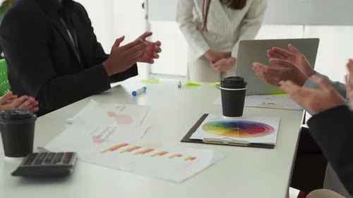 Businesspeople Clapping at Meeting in Office