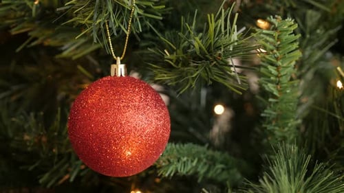 Close-up of red bauble with sequins 4K 2160p 30fps UltraHD footage - Christmas ornament hanged on t