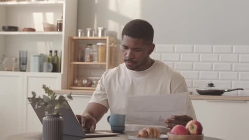 Young Adult Working at Home Using Laptop