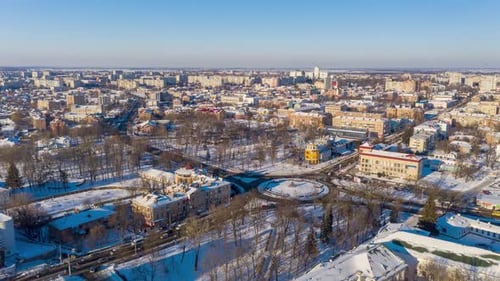 Beautiful winter flight over the city. The whole city is covered in snow. Sunny winter day.