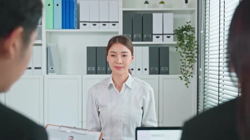 Asian beautiful woman give resume and talking with hr manager for job interview in office.