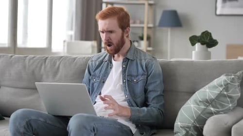 Red-Haired Man Reacts Angrily to Laptop Content