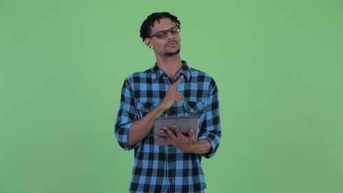 Young Adult Using Tablet and Getting Idea