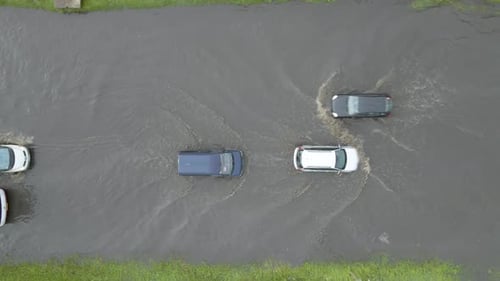 Aerial View of City Traffic with Cars Driving on Flooded Street After Heavy Rain