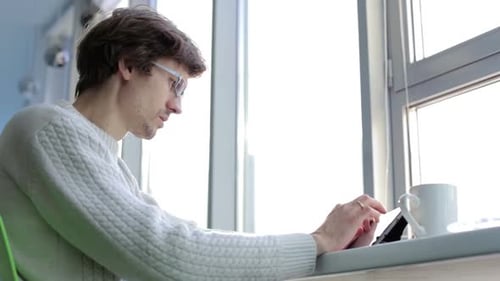 Engineer designer works with drawings on a tablet in the office.