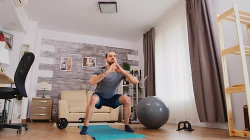 Man Doing Squats For At-Home Workout