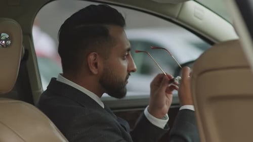 Driver Taking off Sunglasses on Camera