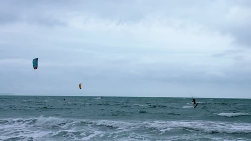 People Kite Boarding in the Sea with Huge Waves