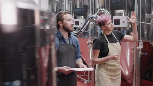 Workers Checking Brewery Equipment In Factory