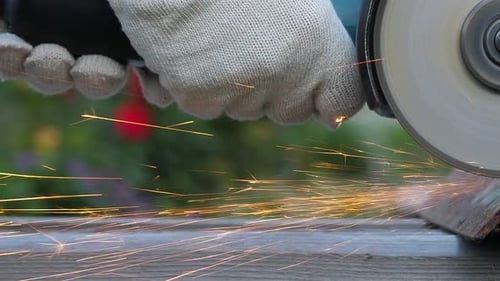 Worker in Gloves Use Angle Grinder