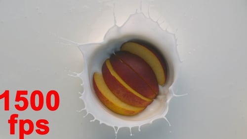 Peach Slices Plunging into White Liquid