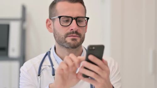 Doctor Uses Smartphone in a Hospital Setting