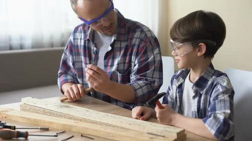 Man Teaches Child Woodworking Project at Home