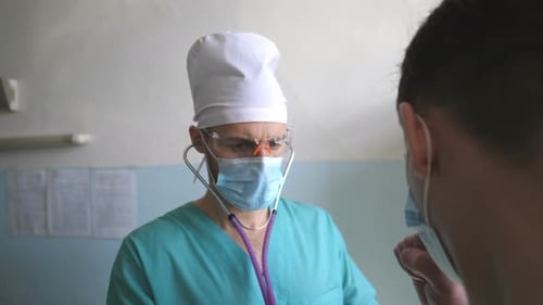 Doctor Examines Patient with Stethoscope in Clinic