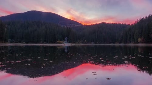 Autumn Sunset at Mountain Lake with Colorful Trees in the Forest