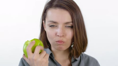 Young Woman Enjoying Green Apple