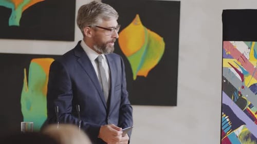 Distinguished Man Presents Art in Gallery