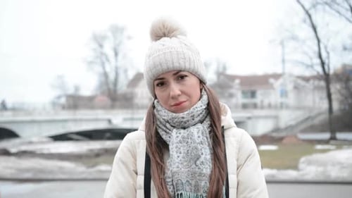 Woman in Winter Hat and Scarf in City Park