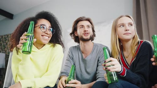 Three Friends Relaxing with Beers at Home