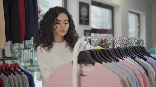 Charming Young Woman Shopping in Boutique