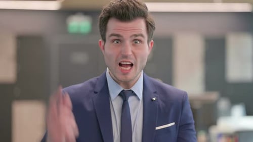 Angry Young Adult Man in Blue Suit Gesturing