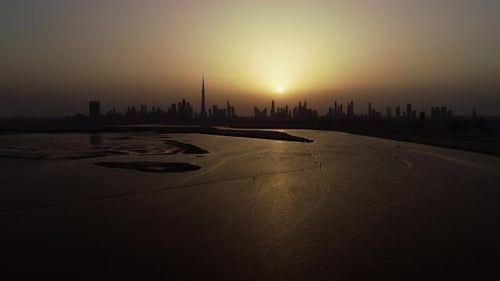 Aerial view of Dubai skyscrapers and bay at sunset, UAE