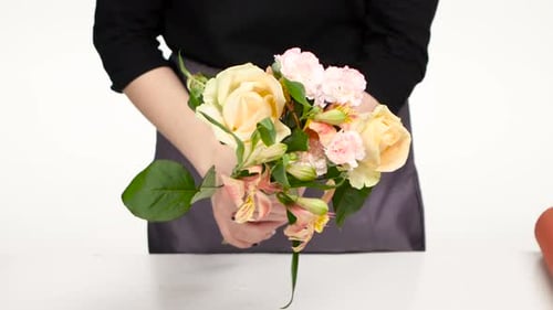 Florist Inserts of Flowers in the Bouquet. White. Time Lapse. Close Up