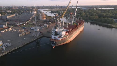 Cargo Ship Docks at a Busy Industrial Port
