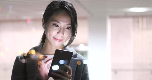 Woman use of mobile phone in city