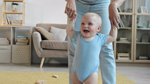 Mother Teaching Toddler to Walk