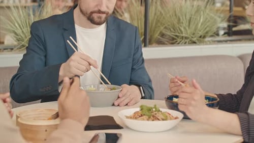 Colleagues Talking during Lunch in Cafe