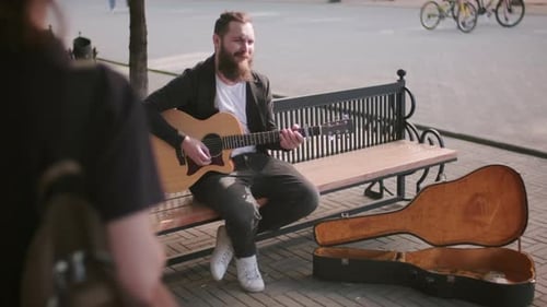 Street Musician Singing and Playing Guitar