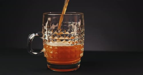 Beer Being Poured into Glass Mug