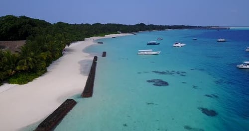Daytime above island view of a sunshine white sandy paradise beach and aqua blue water background in