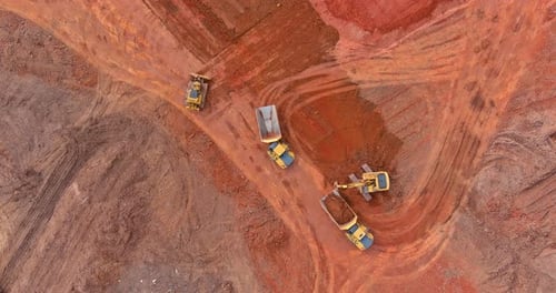 Excavator and Trucks Working on the Excavation Works of a Road Moving Earth