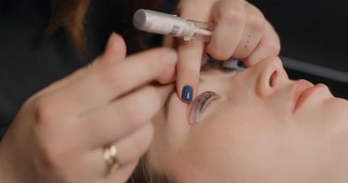 Lashmaker Does the Eyelash Lamination Procedure for the Client in the Beauty Salon Lashes Extension