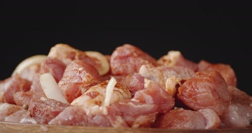 A Bunch of Raw Pork Kebab with Spices Slowly Rotates.