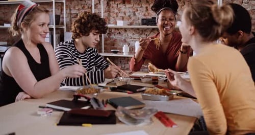 Young Adults Eating Together at Table