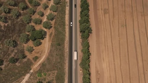 Super slow motion shot of a truck loaded with Shipping container on a rural highway.