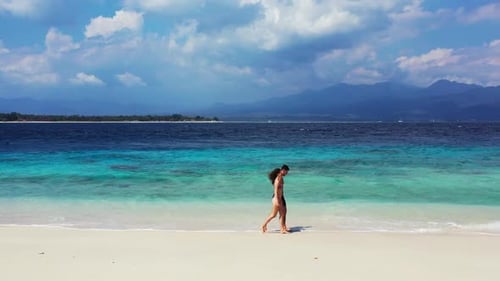 Romantic couple sunbathe on marine lagoon beach time by blue water with clean sand background of Bal