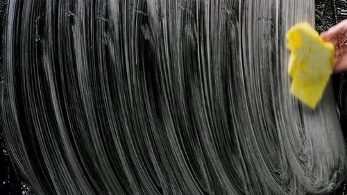 Hand Wiping Soapy Surface